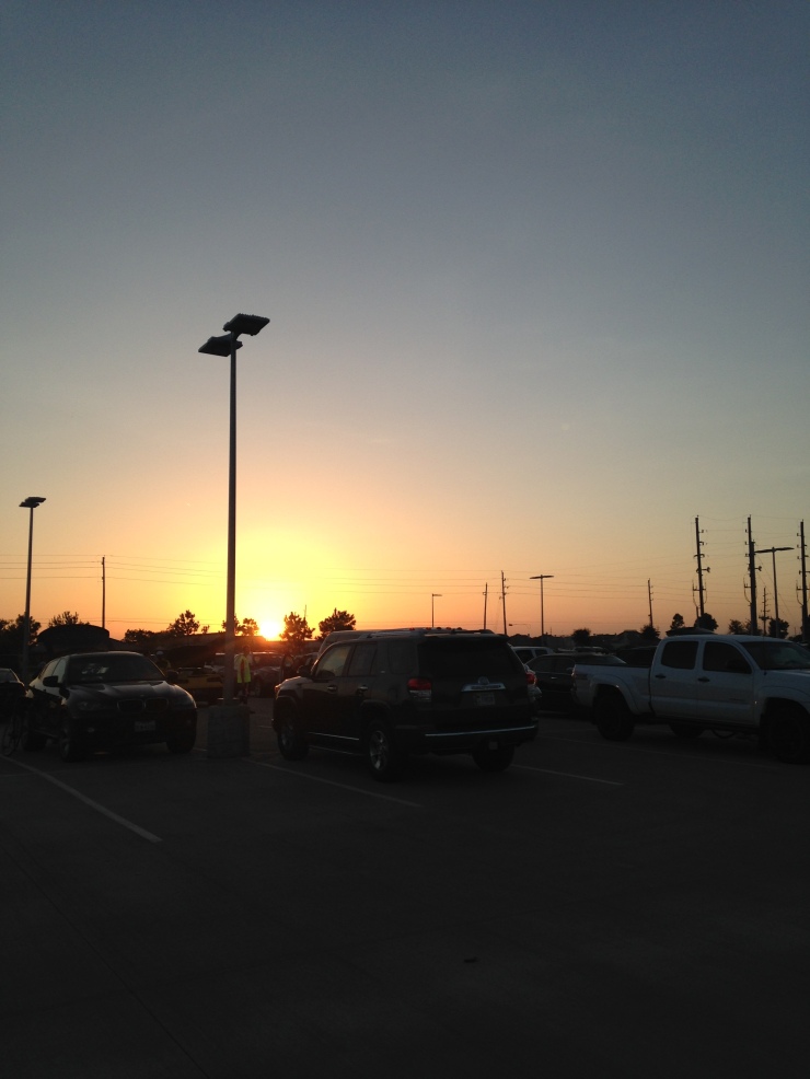 The sun rises over the parking lot. There are about 4000 people trying to get ready to roll.