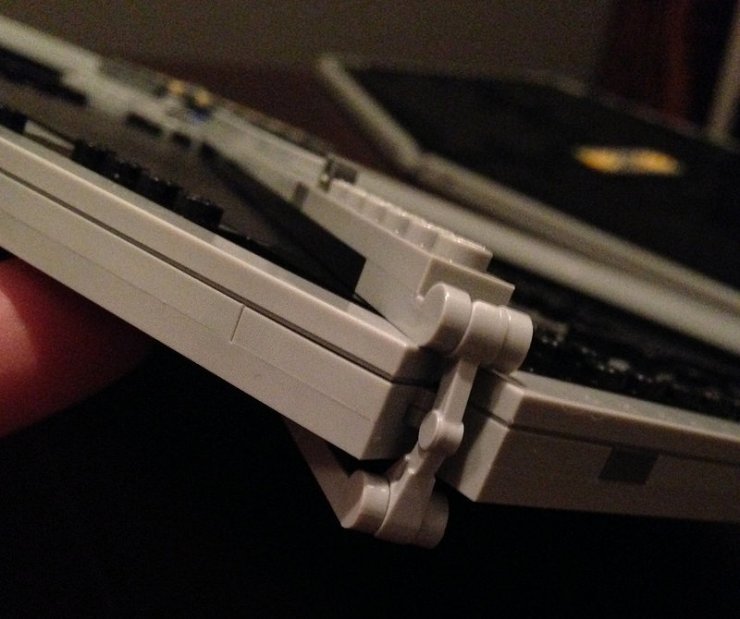 Then after attaching the details on the front side of the panel, this little piece clasps at the bottom of each of the 4 main corners connecting the front and back struts, securing them. Genius!